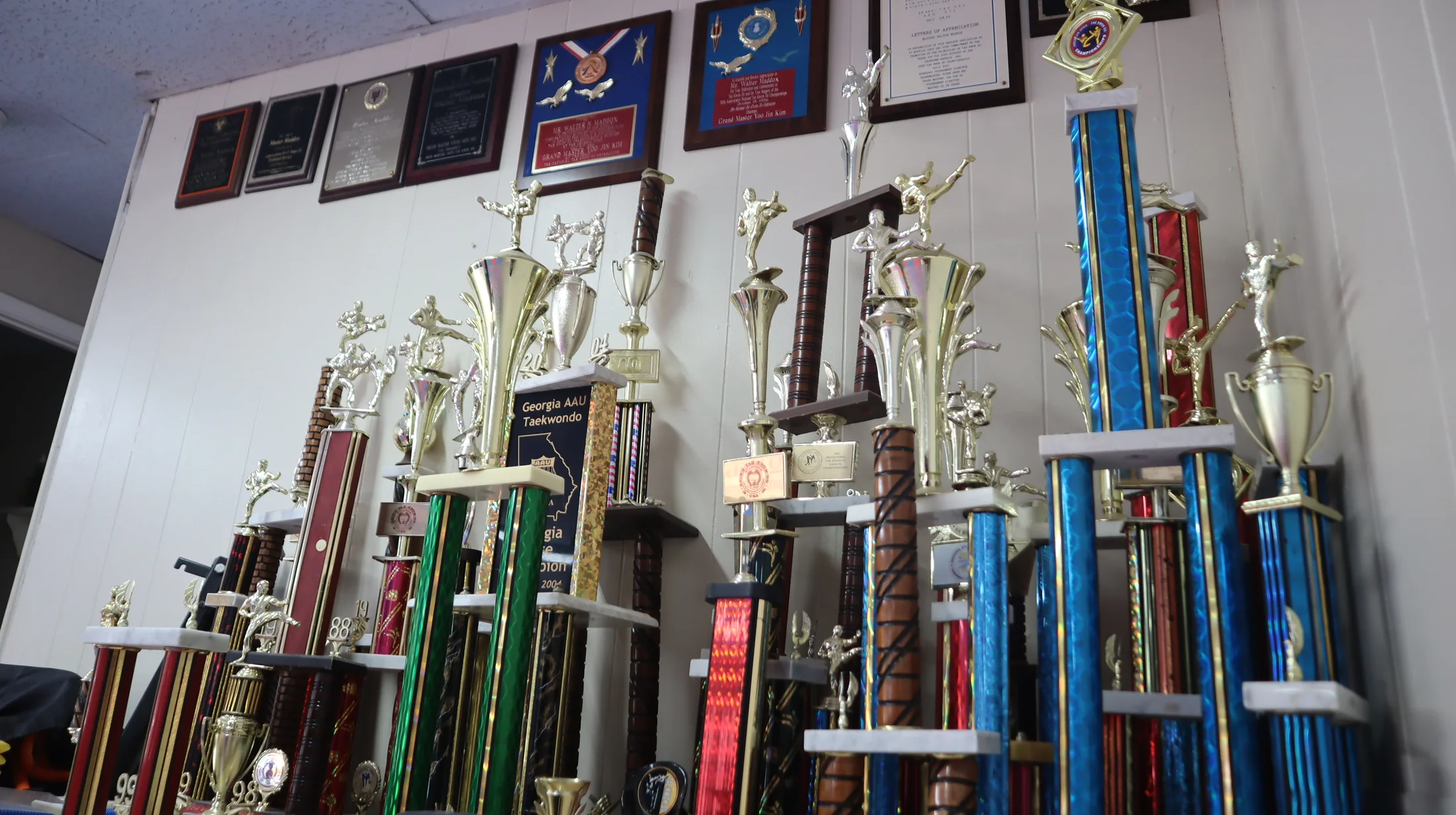 Martial arts trophies and recognition plaques displayed inside Christian Sports Center